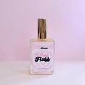 Glass perfume bottle labeled What The Fluff by aspiring aromas